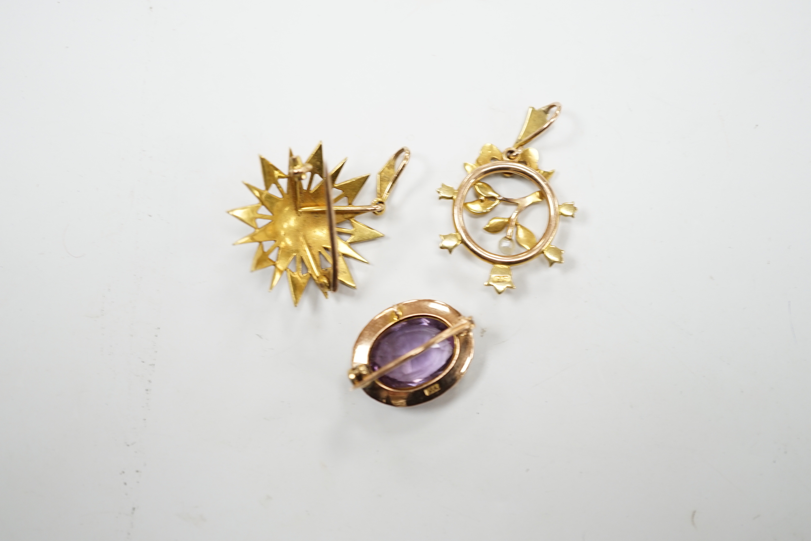 A Victorian 15ct, amethyst and seed pearl foliate pendant and a similar yellow metal and seed pearl set starburst pendant, gross weight 10.6 grams.